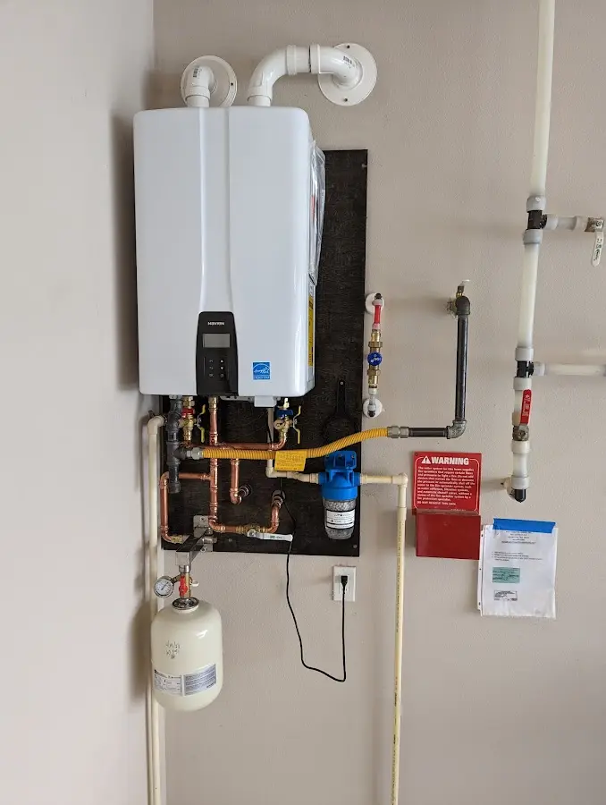 Professional plumber installing copper piping in a Laredo home